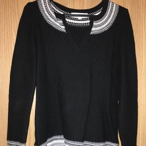 Thick black sweater top with detailed neckline